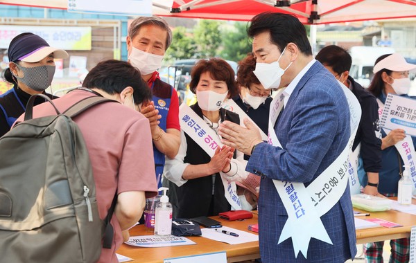 ▲ 백군기 용인시장이 20일 용인중앙시장에서 열린 '이건희 미술관 용인 유치를 위한 서명운동'에서 관계자들과 기념촬영을 하고 있다. ⓒ 뉴스피크